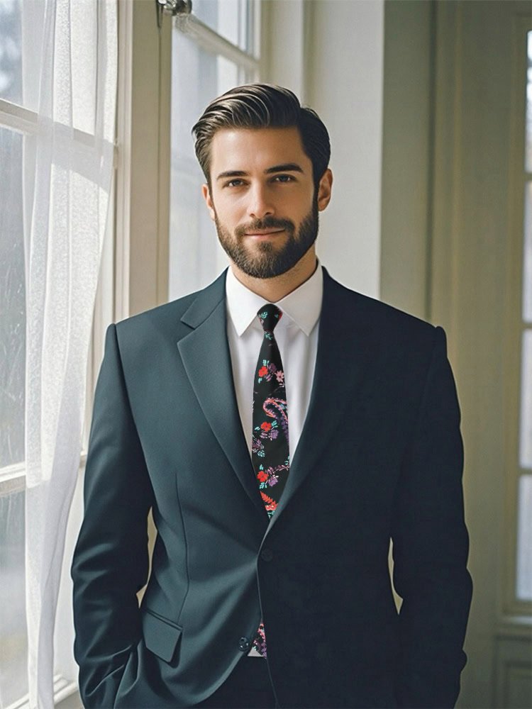 A well - dressed male model wearing a Midnight Paisley Floral Tie.