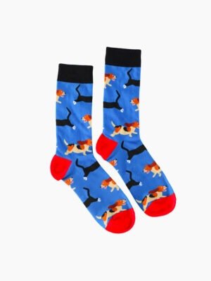 A pair of blue socks with a pattern of puppies in various poses, black cuffs, and red heels and toes.