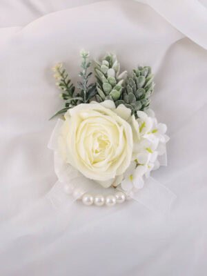 Ivory rose corsage with green foliage, white ribbon and pearl accents