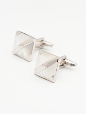 A pair of geometric - shaped silver cufflinks with a shiny finish.