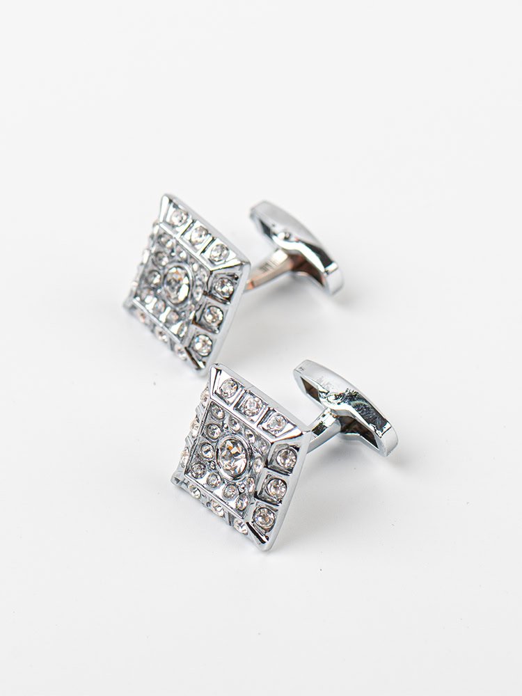 A pair of square - shaped silver cufflinks embellished with numerous sparkling crystals.