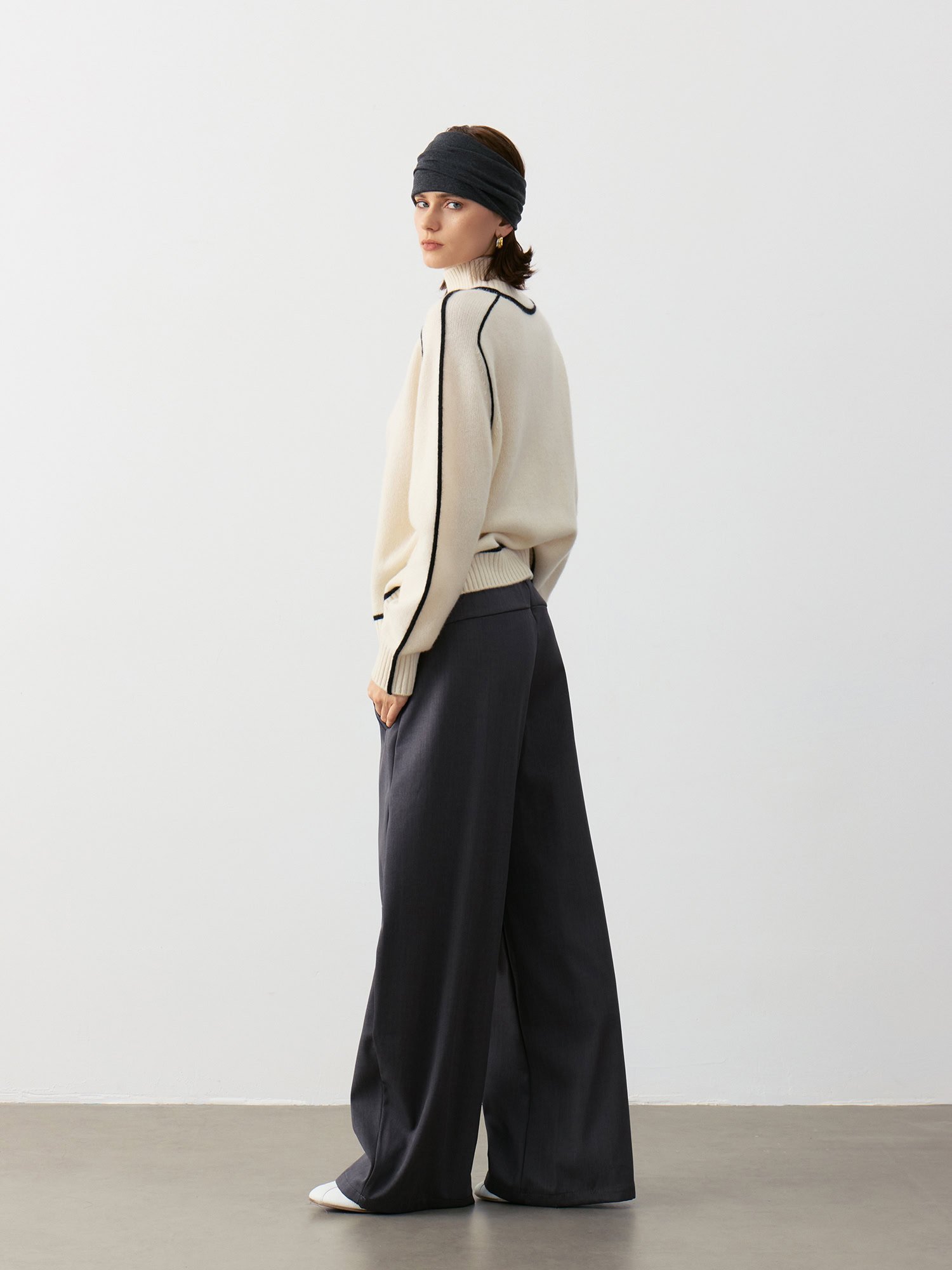 Luxury Rebel 100% Cashmere Black & White Oversized-Sleeve Sweater Outfit | Side View with Dark Grey Wide-Leg Pants - Edgy Luxury