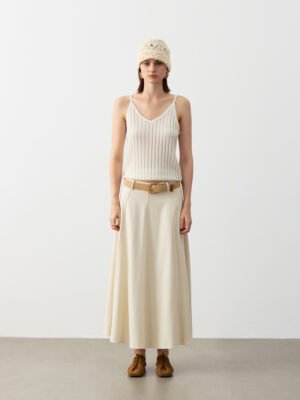Model Wearing Pure Cashmere V-Neck Ribbed Camisole with Beige Maxi Skirt, Brown Belt, Knit Beanie, and Brown Shoes