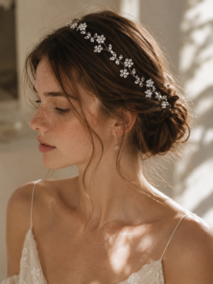 Silver blossom bridal hair vine styled across soft side-swept bridal hair