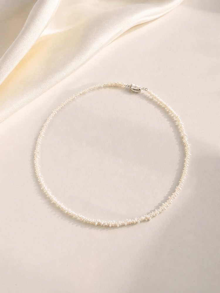 Natural saltwater keshi pearl necklace on soft silk with organic pearl texture and silver clasp