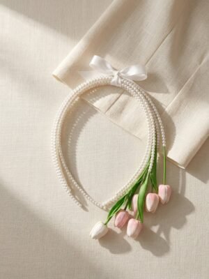 Bride holding a pearl tulip bridal bouquet with soft pink flowers and fresh green leaves